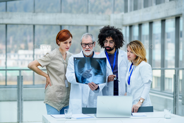 Group of doctors looking at X-ray on medical conference, discussing issues