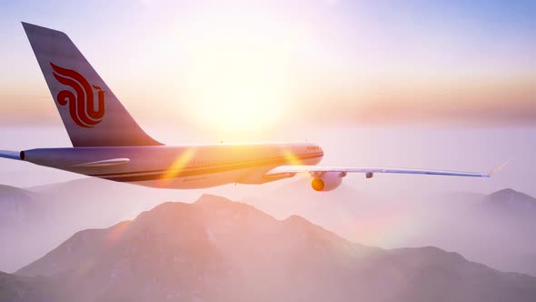 The airliner flew over the misty mountains at dawn alt