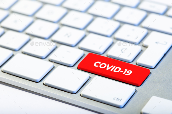 Keyboard with red key and COVID-19 message - Stock Photo - Images