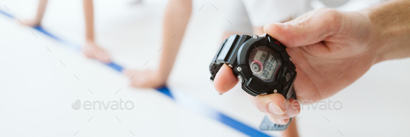 Trainer measures the time of children during the school race