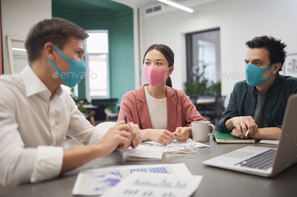 Business people in protective masks