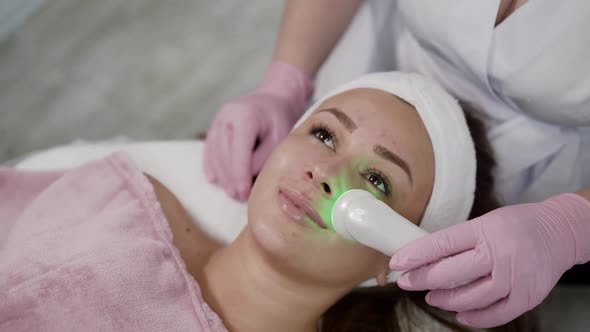 Pretty Girl Having Relaxing During Laser Cosmetology Procedure By Beautician alt