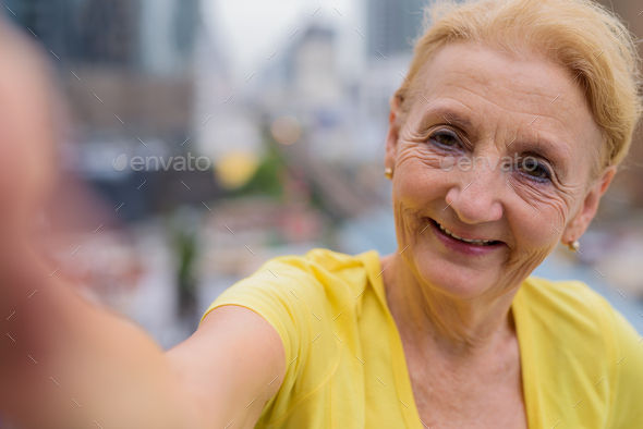Personal point of view of senior woman taking selfie with mobile phone