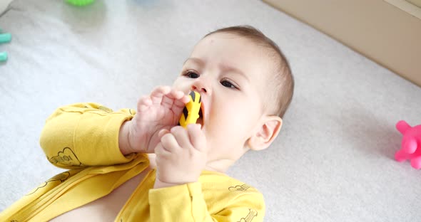 Mom Dresses a Little Boy on the Bed alt