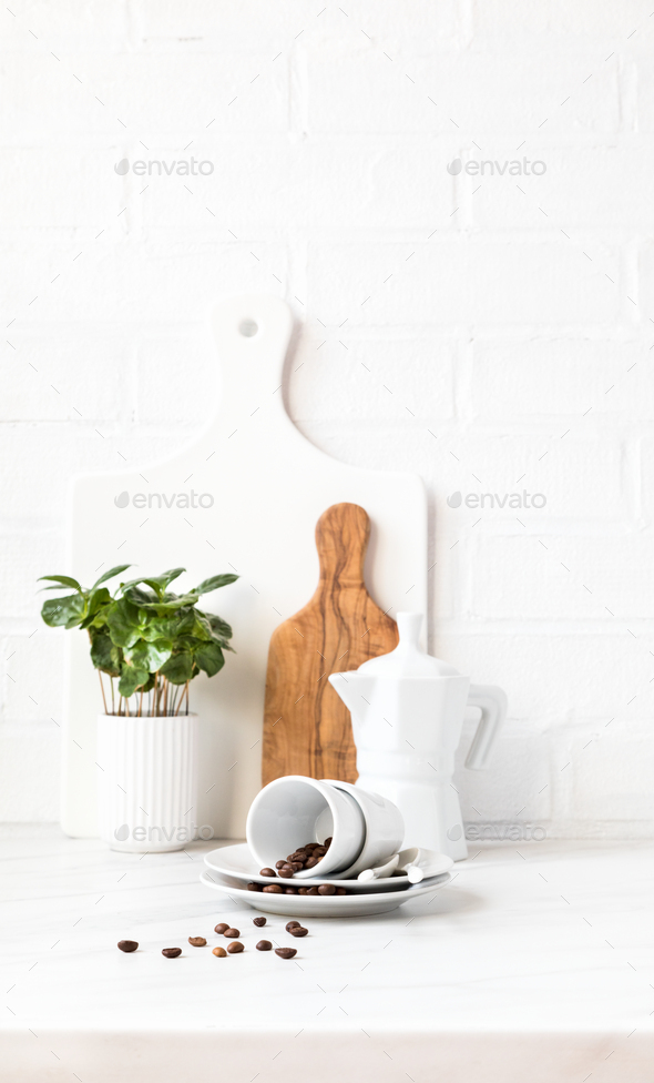 Kitchen utensils on a background of a white brick wall. Concept of the decor of the kitchen.