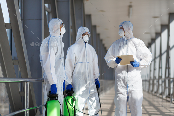 Men in virus protective suits planning to disinfecting city