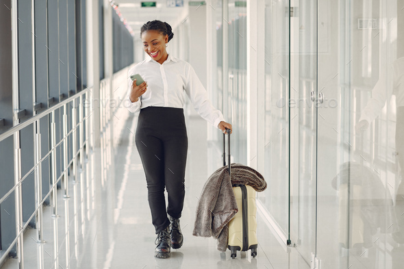 Black woman with suitcase at the airport