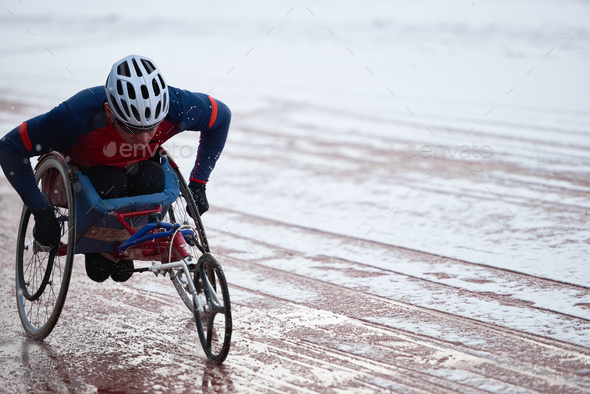 Wheelchair racing. Physically impaired male athlete in helmet training