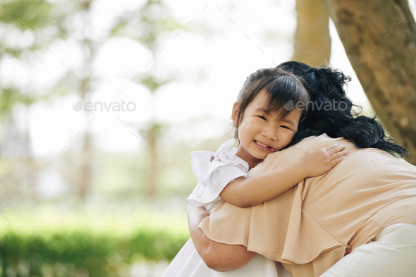 Crying girl hugging grandmother