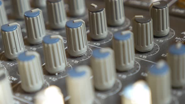 Audio mixing console buttons and dials close-up 4K 2160p 30fps UltraHD panning video - Audio mixer s alt