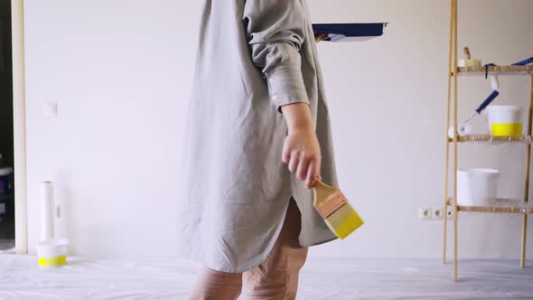 Lady in Long Grey Shirt Begin Renovate Flat