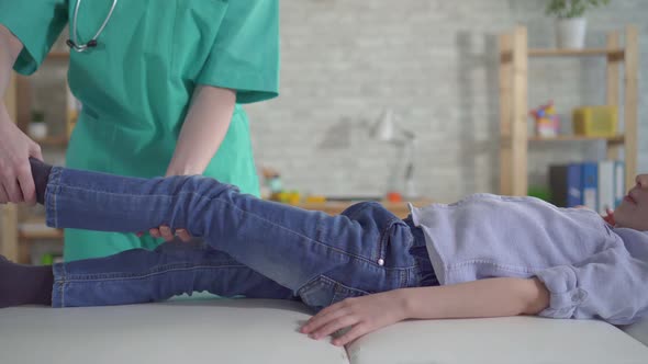 Little Boy with Leg Pain at Physiotherapist's Appointment alt