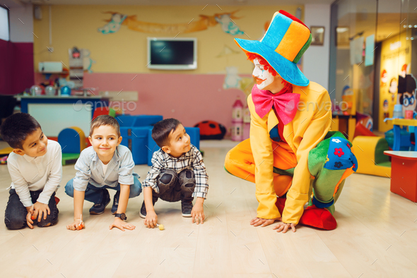 Clown animator play with group of little boys