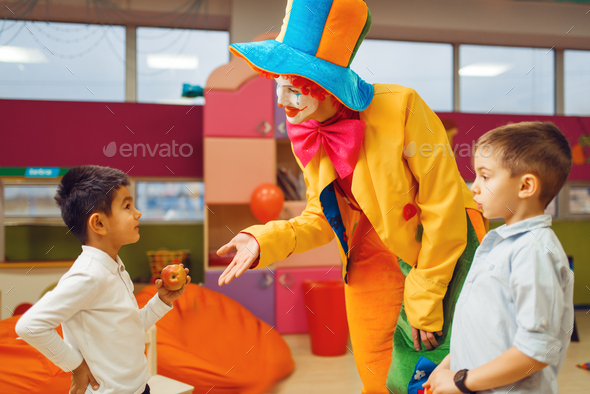 Funny clown animator dancing with little boys