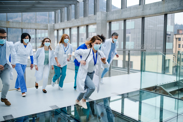 Group of doctors running in corridor of hospital, emergency concept