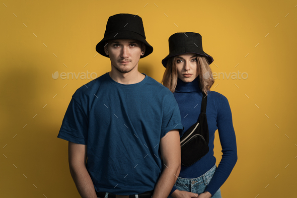 Portrait young couple on yellow background