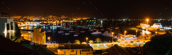 Panoramic night picture of Mindelo city in twilight. Port town with many boats in the lagoon on the