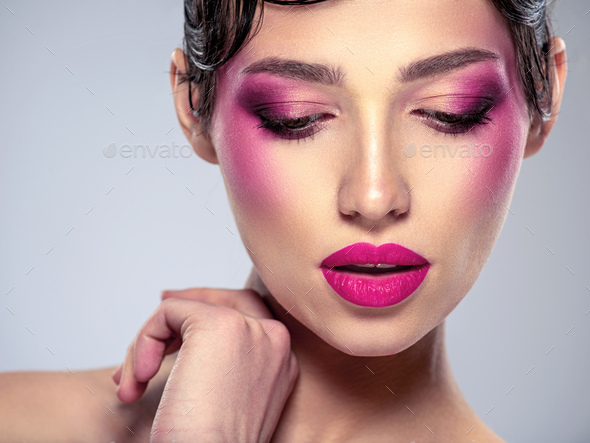 Beautiful fashion woman with a purple lipstick on her lips. - Stock Photo - Images