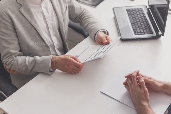 Job interview in the office. hr manager reading resume of job seeker - Stock Photo - Images