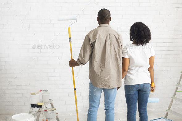 African american couple planning to paint new home interior