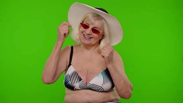 Senior Pensioner Woman Tourist in Swimsuit Bra Red Sunglasses and Hat Dancing Celebrating Smiling alt