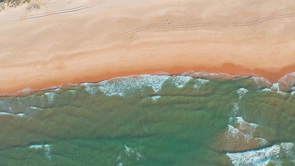 Flight Over the Sandy Beach and Waves