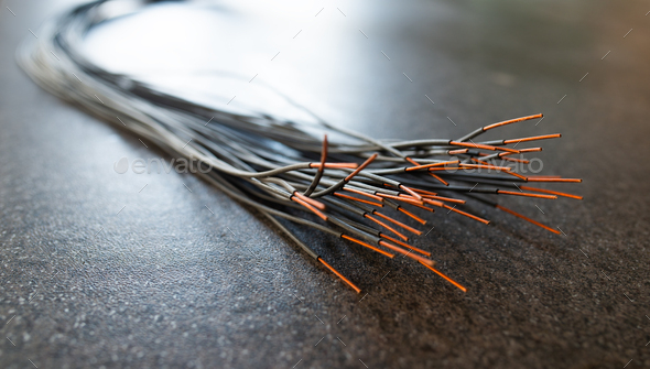 Bundle of cut thin wires with red connections Stock Photo by YouraPechkin