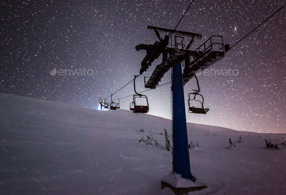 Cable cars hang on cables in a silent night