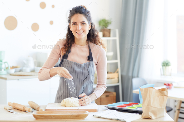 Woman Adding Flour To Dough - Stock Photo - Images