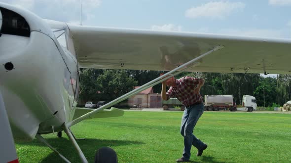 Professional Pilot Airplane Making Preflight Inspection Process Checking Wings alt
