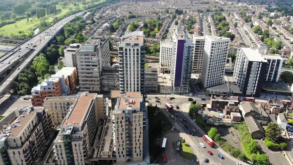 Reverse aerial shot of residential buildings in Ilford, London on a sunny day alt