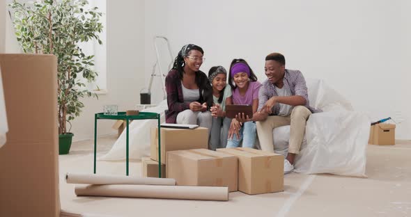 Video Call Tablet Married Couple and Their Children Call Family Via Internet to Show Renovated alt
