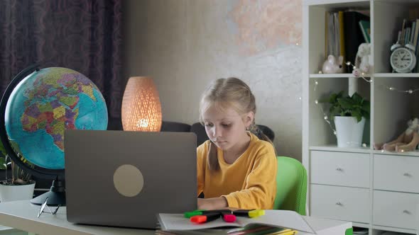 Schoolgirl Makes Homework with Laptop