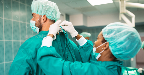 Team of surgeons in the operating room preparing for surgery Stock Photo by  nd3000
