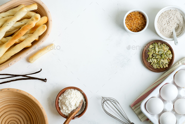 Natural organic ingredients for baking homemade traditional bread or cakes on a light grey marble - Stock Photo - Images