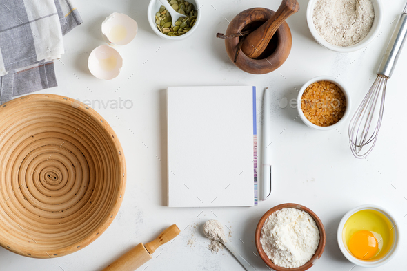 Baking ingredients for cooking homemade traditional bread with paper for recipe on a light grey - Stock Photo - Images