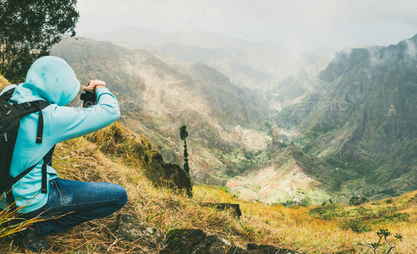 Traveler takes a picture of a gorgeous panorama view of a lush green Xo-xo valley. Santo Antao