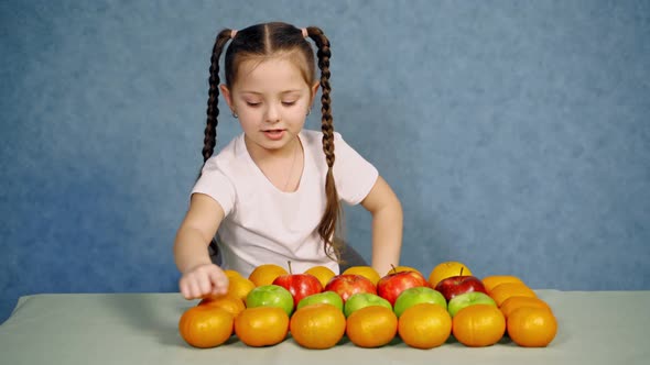 Children at table with fruit. Portrait of little girl sitting at table with fruit alt