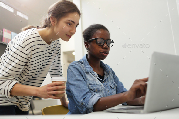 Two colleagues discussing online work