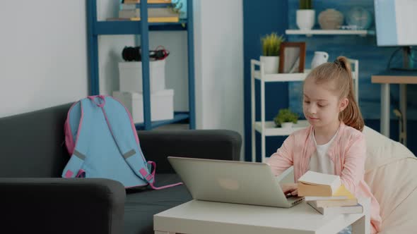 Cheerful Girl Looking at Laptop Screen for Online Remote Classes alt