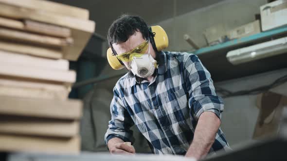 A Man Works with a Planer alt