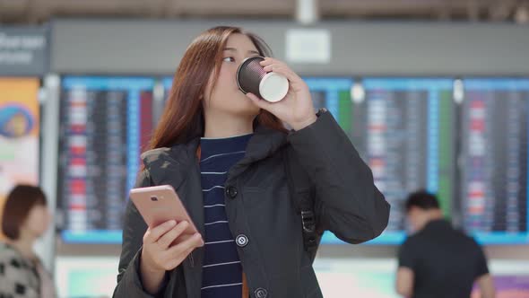 Young traveler female check in with smartphone at airport