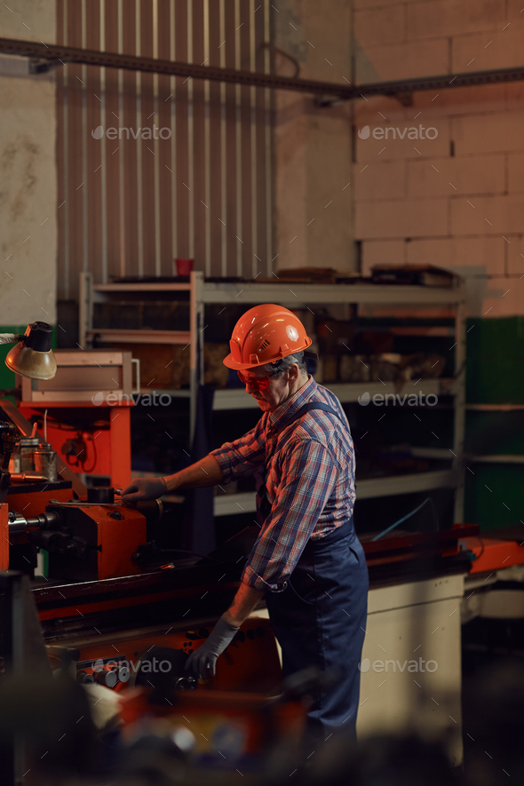 Mechanic working at the lathe Stock Photo by AnnaStills PhotoDune