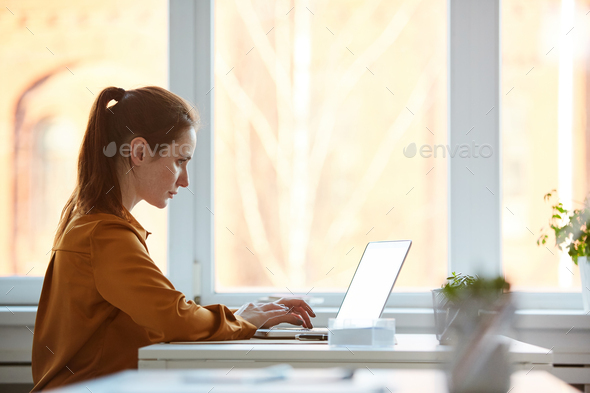 Young businesswoman typing on laptop