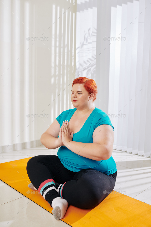Meditating plus woman Stock by DragonImages | PhotoDune