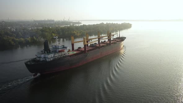 Slowmo Aerial Cargo Bulker with Bulk Commodities Sailing From Seaport After Loading Coarse Grain on alt