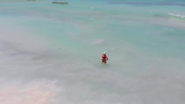 Aerial View Woman in Clear Turquoise Ocean on Paradise Sandy Beach Zanzibar alt