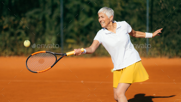 Smiling Elderly Woman Playing Tennis as a Recreational Activity