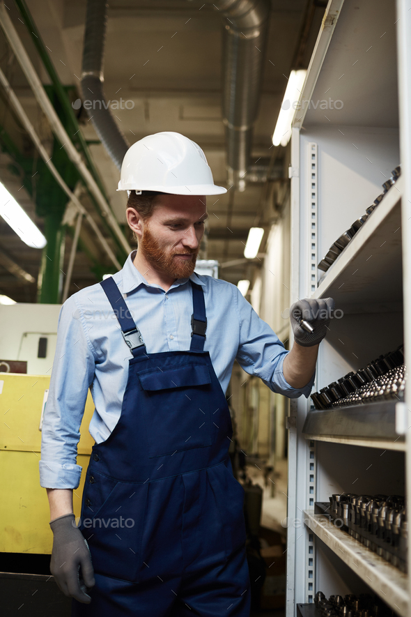 Mechanic working in warehouse Stock Photo by AnnaStills PhotoDune