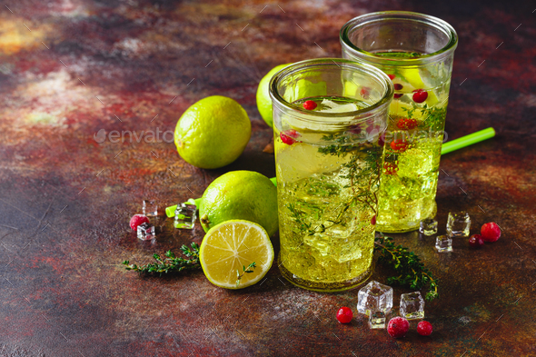 Lime Lemonade with thyme, cranberry and ice. - Stock Photo - Images